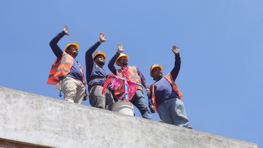 Un grupo de trabajadores de la construcción saludan a quienes los felicitan en su día. (Foto: MICIVI)